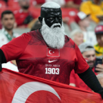 Udi Neco, suporter legendaris Timnas Turki, tampil mencolok dengan riasan khas "Black Bull" saat mendukung negaranya di Piala Dunia 2026. Penampilan uniknya menjadi sorotan dan simbol loyalitas tanpa batas bagi sepak bola Turki.